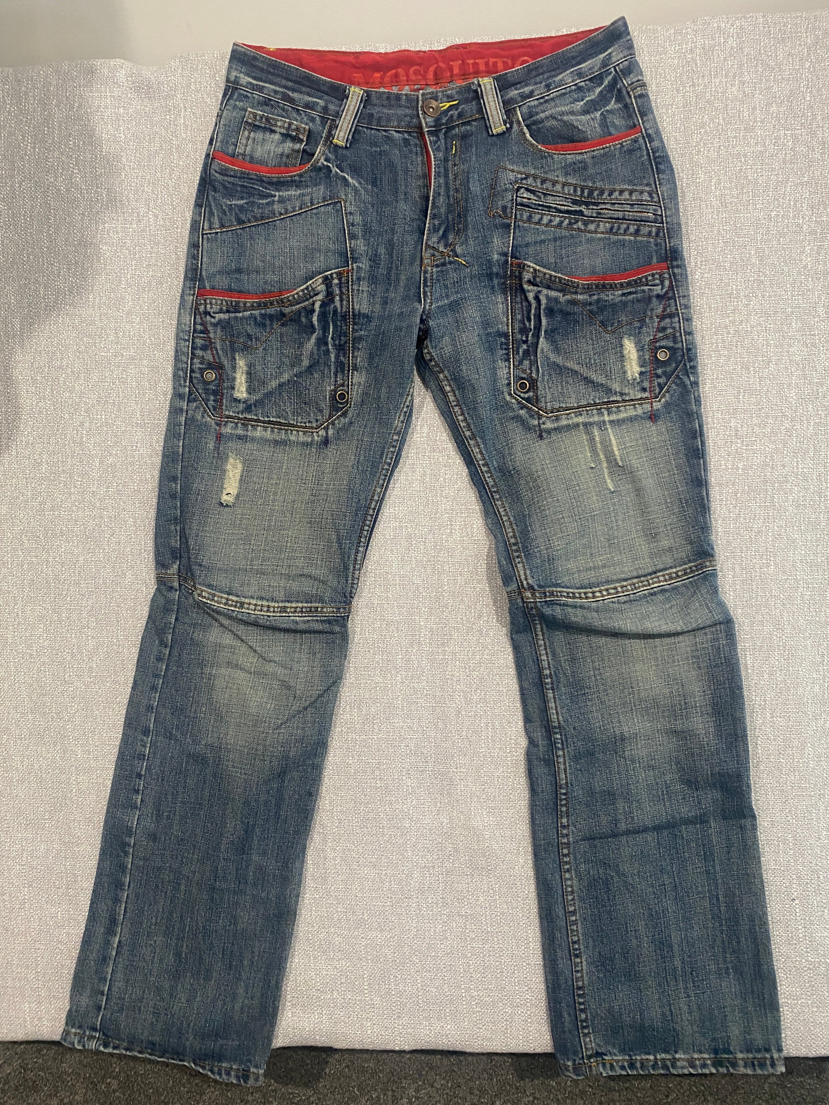 Mosquito Distressed Multi-Pocket Blue Jeans with Red Accents