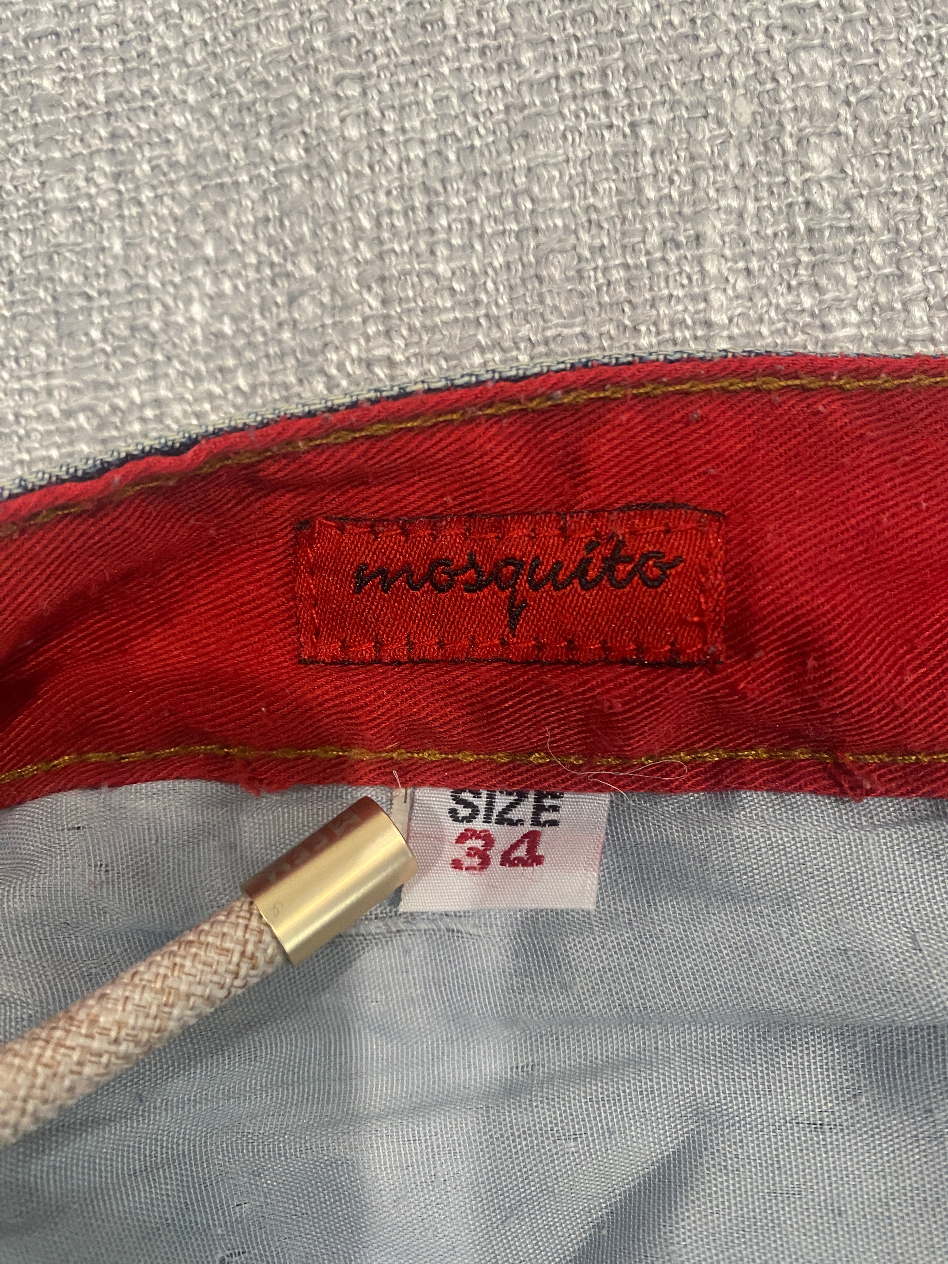 Mosquito Distressed Multi-Pocket Blue Jeans with Red Accents