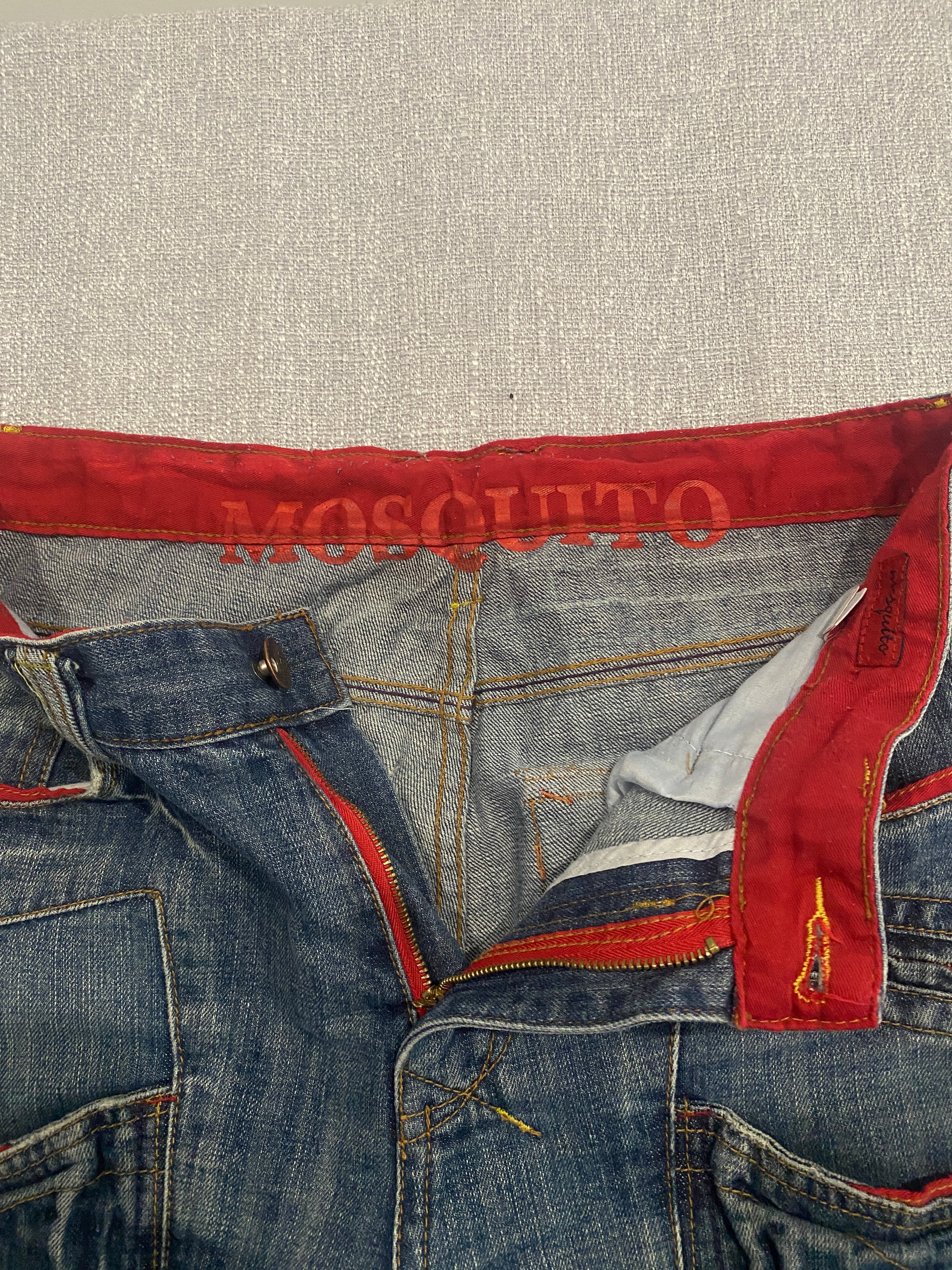 Mosquito Distressed Multi-Pocket Blue Jeans with Red Accents